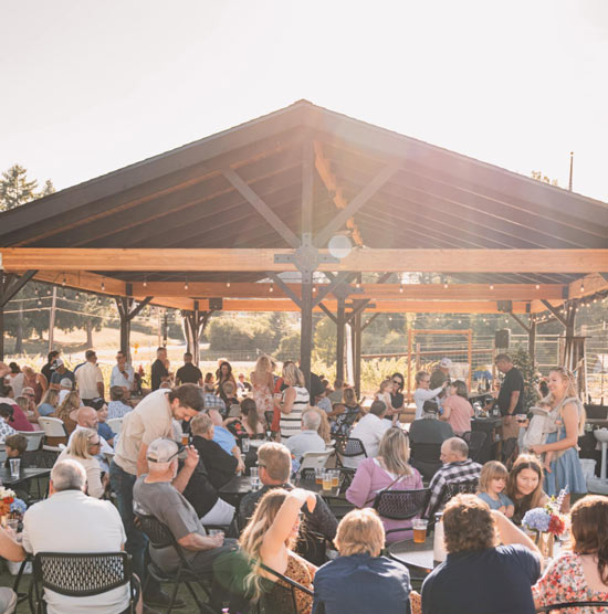 Guests gathered under the event pavilion at sunset